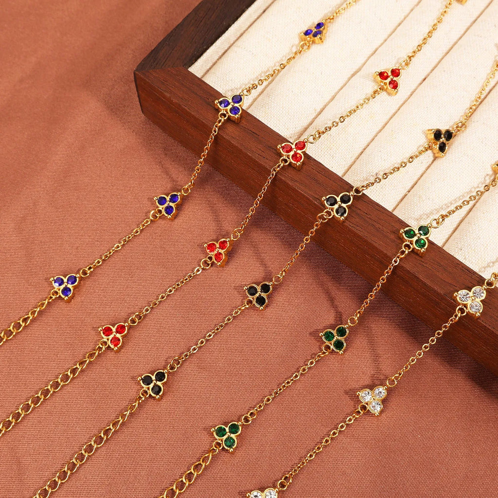 Women's stainless steel geometric bracelet with triangle design and coloured zircon stones.