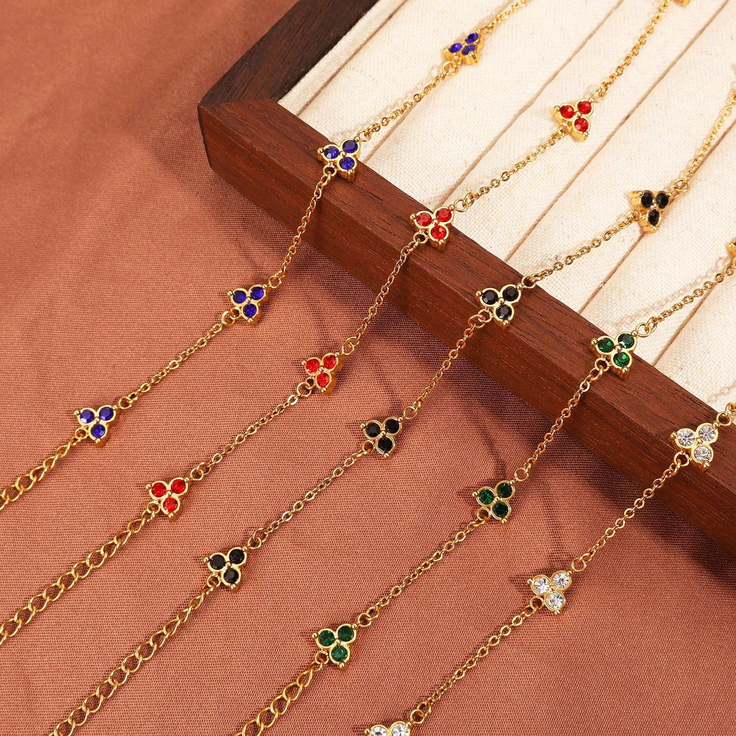 Women's stainless steel geometric bracelet with triangle design and coloured zircon stones.