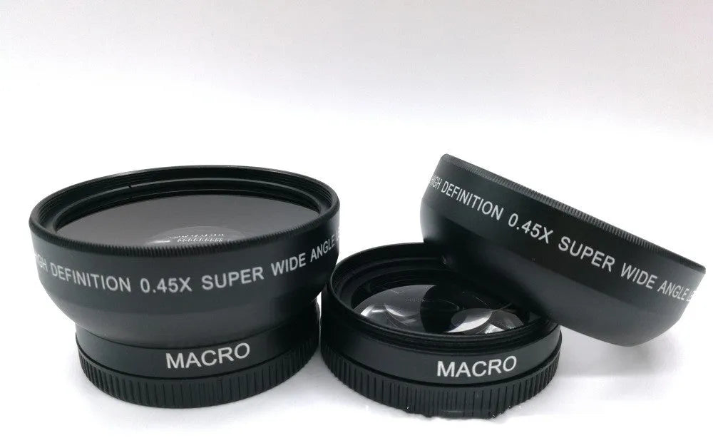 Black 52mm wide-angle macro camera lens with front and back covers on a table