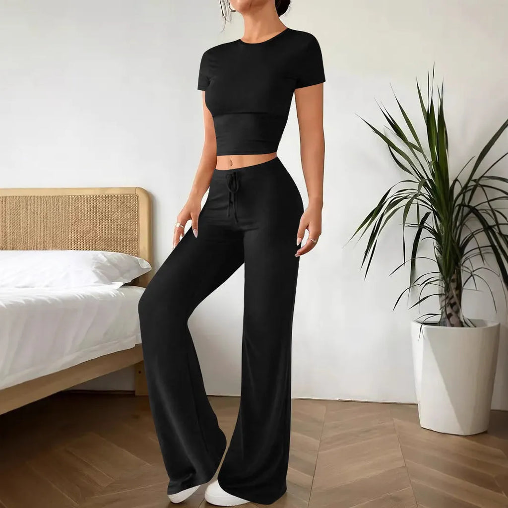 Black women's high waist trouser and short sleeve t-shirt co-ord set on a hanger.