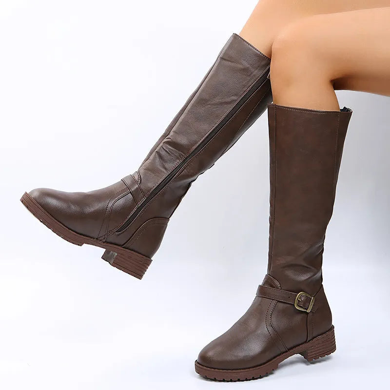 Women's black knight boots with a square heel, high shaft, and a front belt buckle fastening.