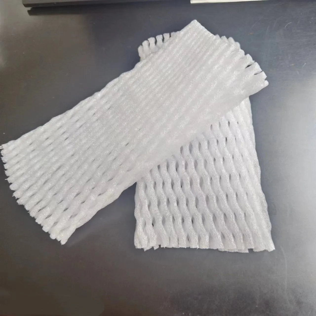 White foam protective net sleeve for fruit and delicate items, shown in multiple sizes.