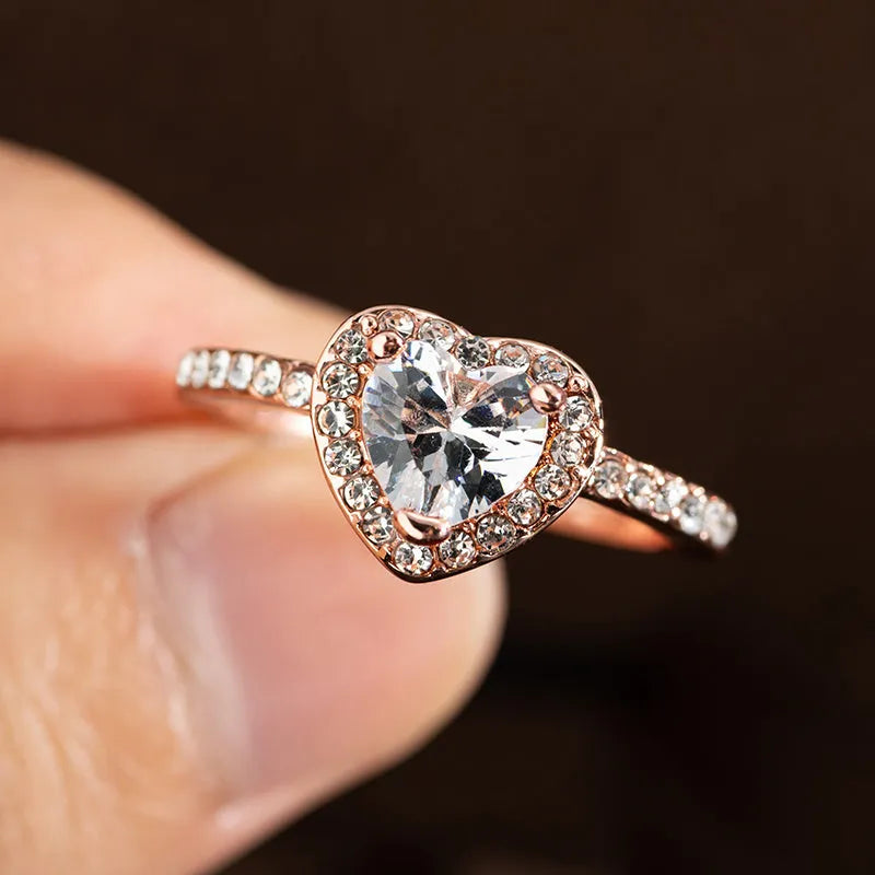 Heart-shaped women's fashion ring with crystal details in rose gold or silvery electroplated finish.