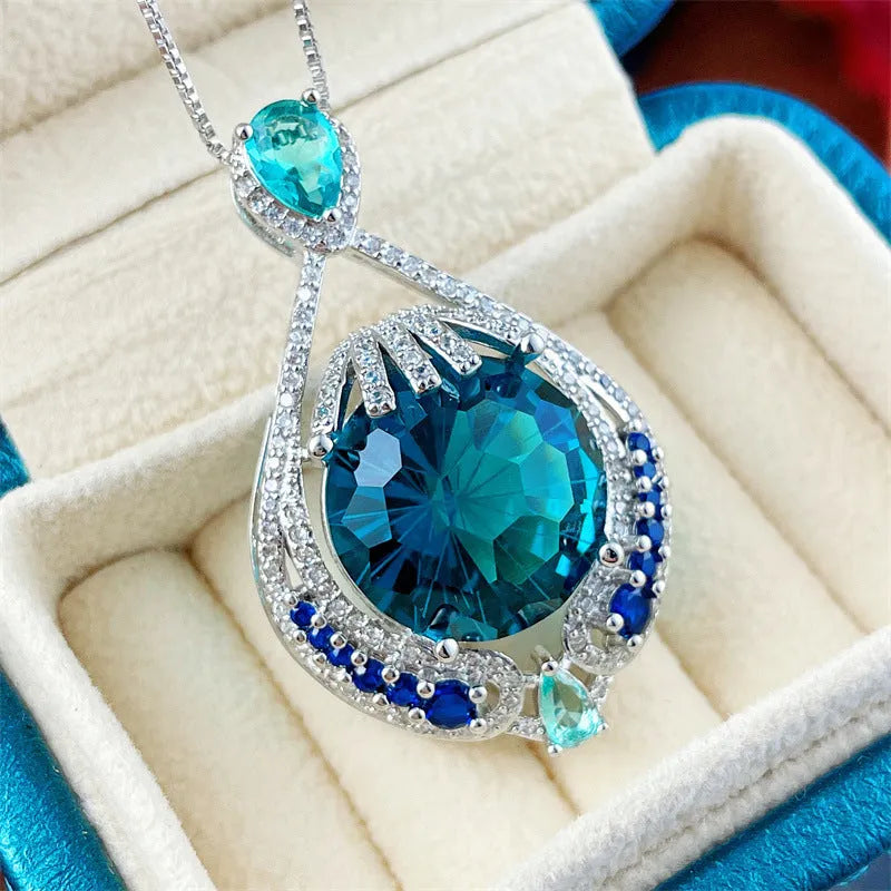 Blue geometric crystal pendant necklace on a water wave chain for women.