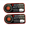 A pair of white and red electrostatic warning stickers for Tesla car windows measuring 11 by 5 cm.