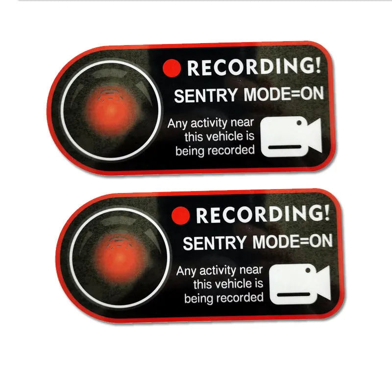 A pair of white and red electrostatic warning stickers for Tesla car windows measuring 11 by 5 cm.