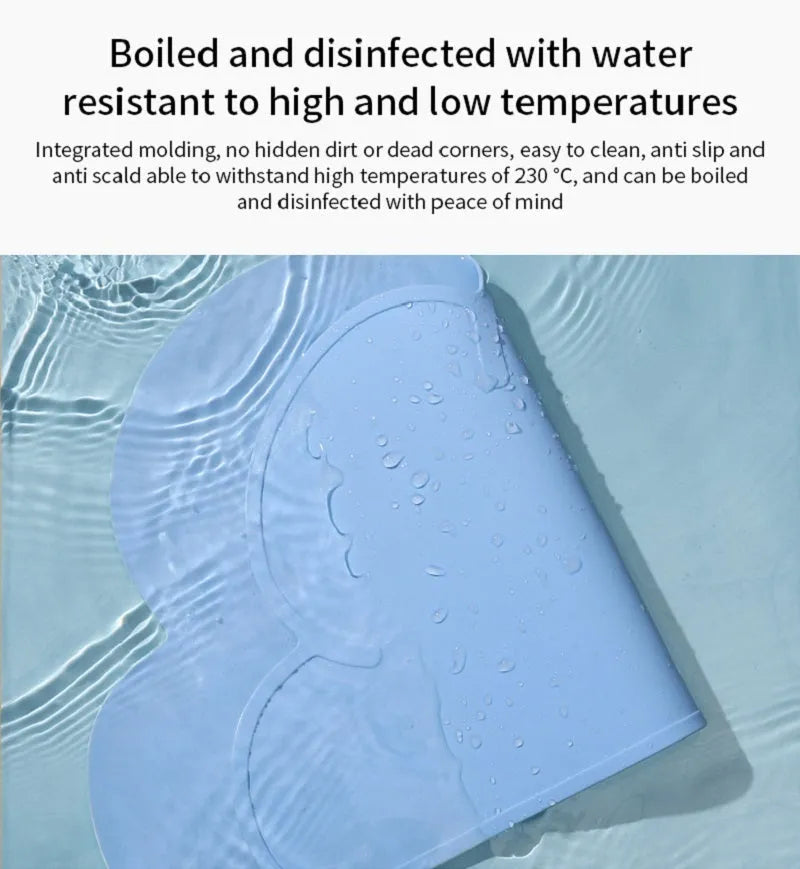 Blue silicone pet feeding mat under food and water bowls measuring 44 by 24 centimetres