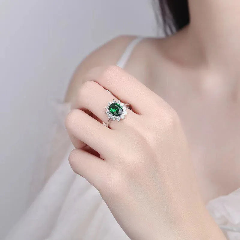 Women's floral ring with blue moissanite stone on electroplated copper band, shown in green, sapphire blue, and pomegranate red colour options.