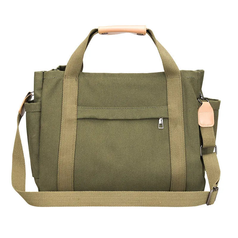 Army green canvas tote bag with open zip sides showing internal laptop and camera pockets.
