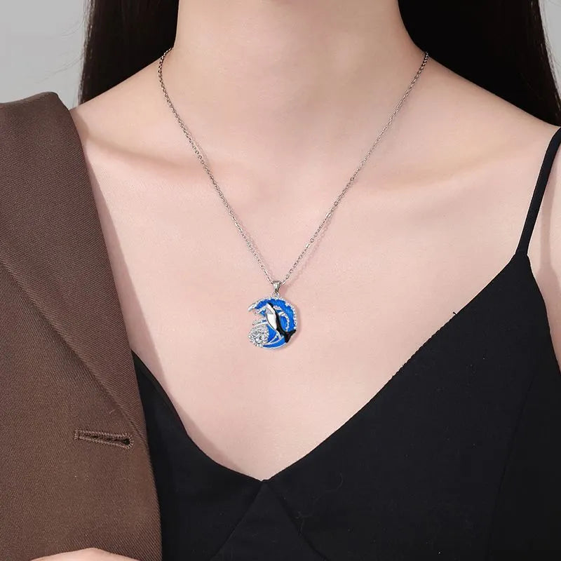 Silver shark pendant necklace on a cross chain, adjustable between 41cm and 50cm.