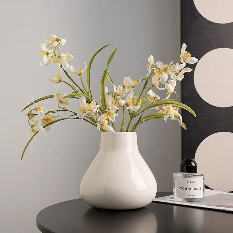 Ceramic round belly decorative vase with coloured glaze and artificial flowers in black or white