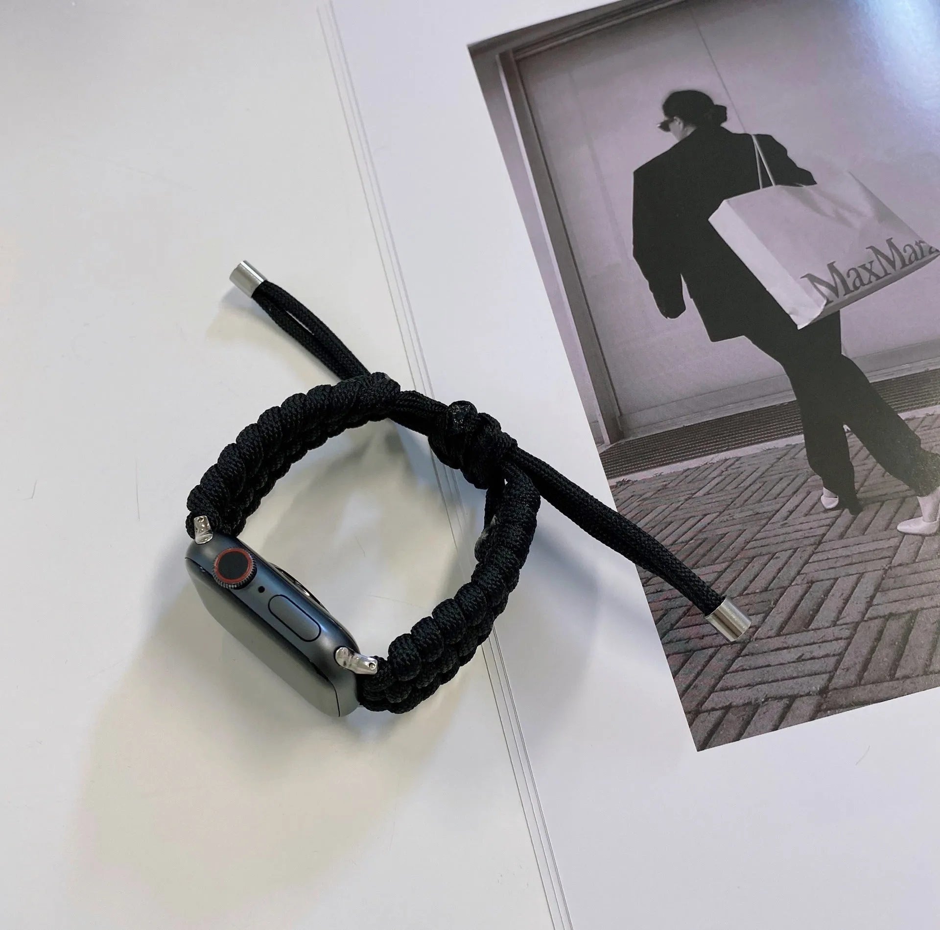 Paracord braided smartwatch strap in black showing textured nylon cord construction and standard watch lugs.