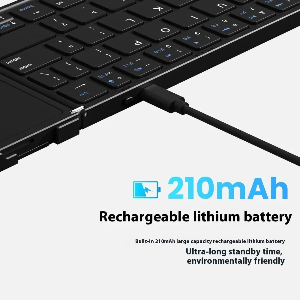 Black folding Bluetooth keyboard with touchpad unfolded next to mobile phone