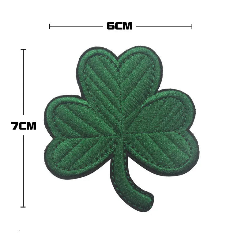 Embroidered fabric badge with Velcro backing showing detailed clover leaf pattern in green thread