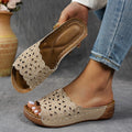 Women's wedge heel beach slippers with flower cutout design on black PVC upper.