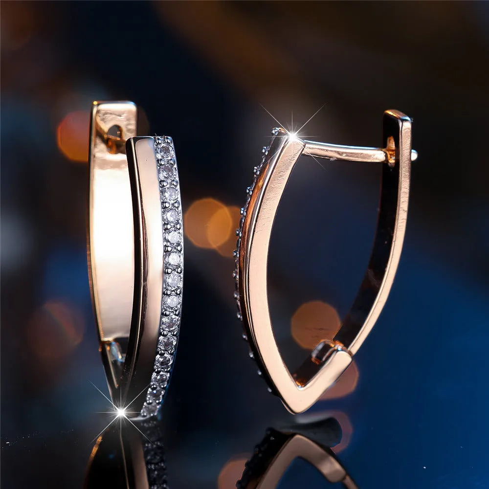 Geometric V-shaped women's earrings in champagne gold white diamond colour.