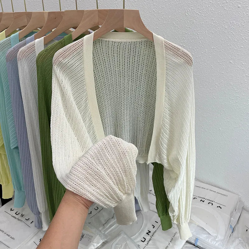 Thin polyester blouse with long hollow lantern sleeves in apricot colour, slim fit.