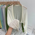 Thin polyester blouse with long hollow lantern sleeves in apricot colour, slim fit.