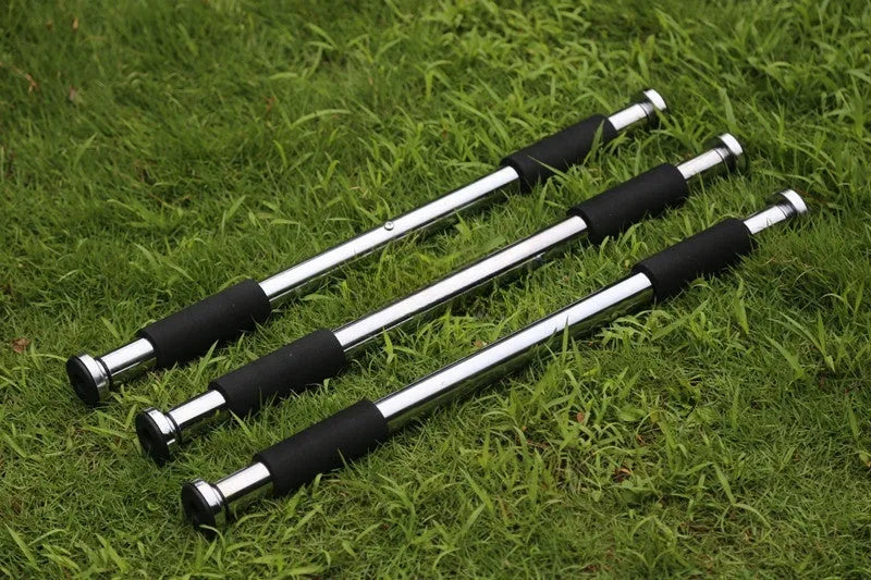Adjustable steel pull-up bar extended across doorway showing parallel grip positions