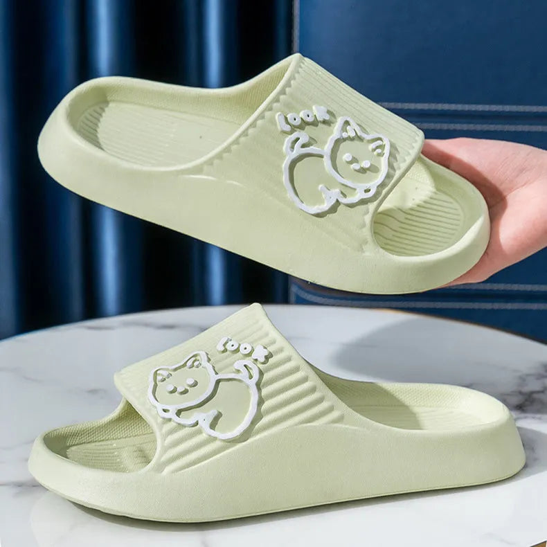 Women's cat platform slippers in pink with thick EVA sole, shown on a wooden floor.