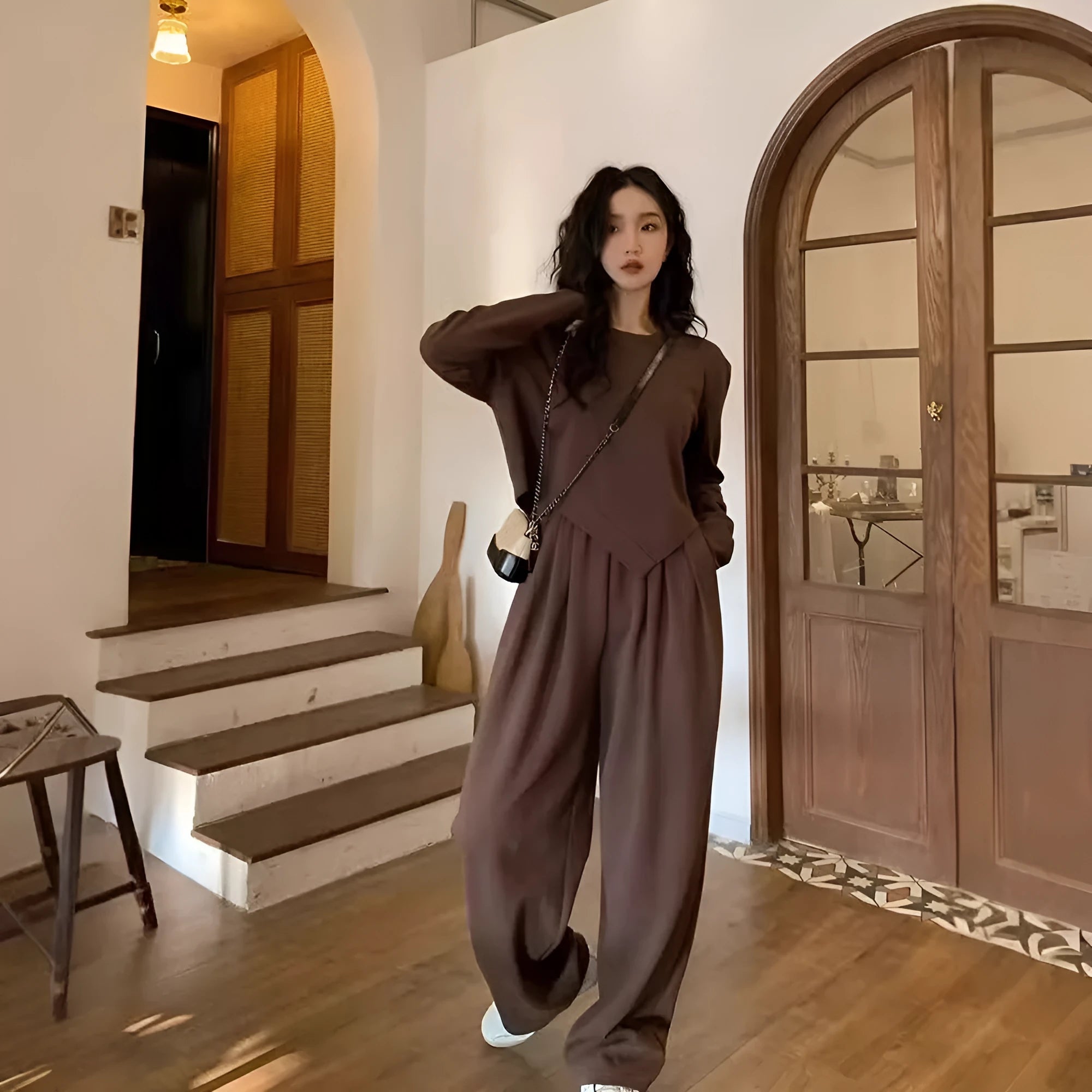Women's khaki casual sports suit set with long sleeve top and matching trousers on a hanger.