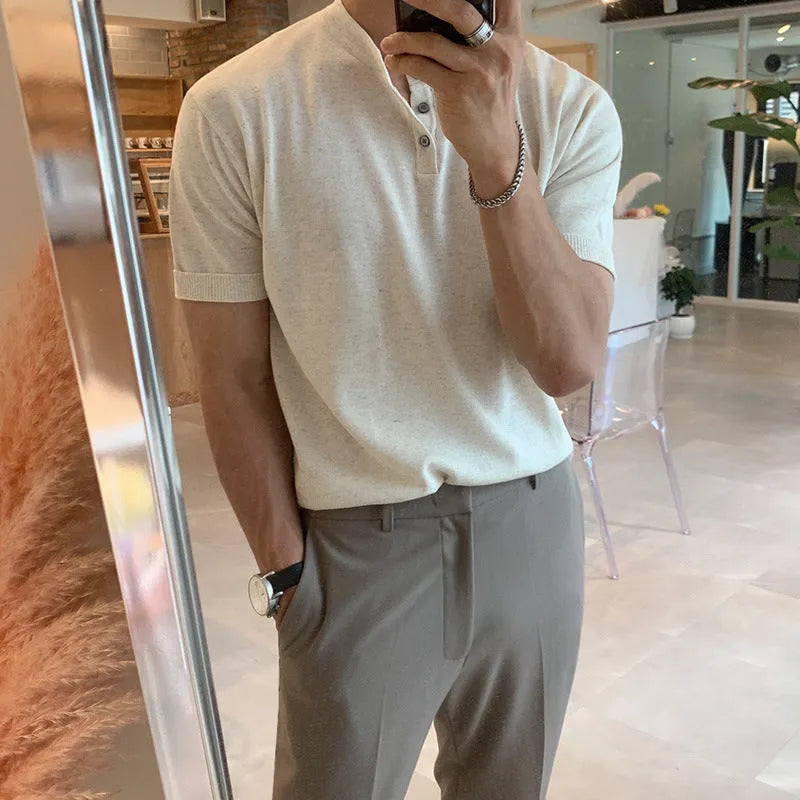 Man wearing a thin black short-sleeved ice silk knitted pullover shirt with a slim loose fit.