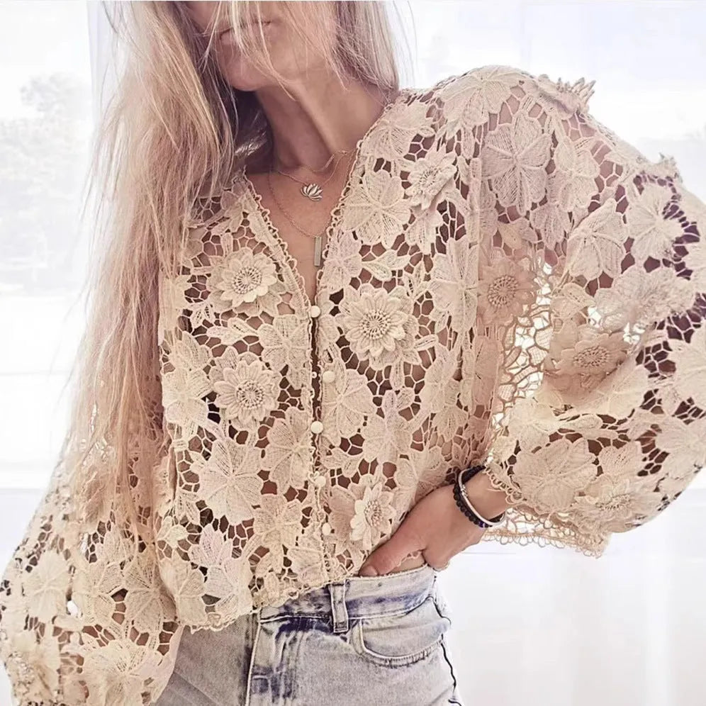 Black lace v-neck cardigan with three-dimensional white flower decorations on the sleeves.