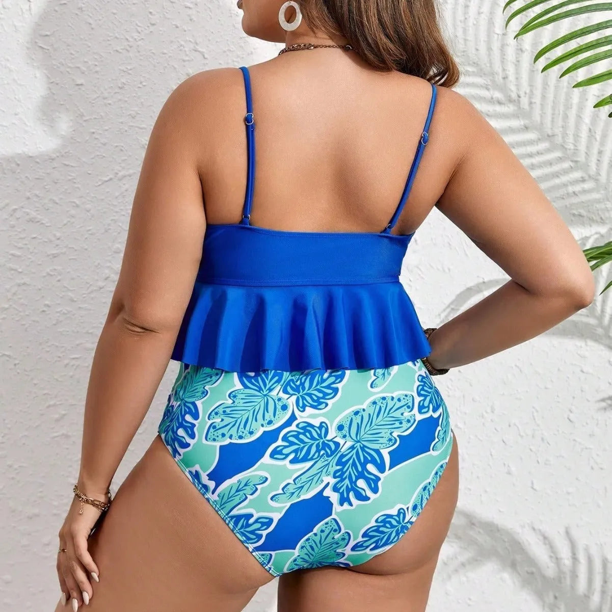 Blue two-piece polyester bikini set on a mannequin, showing top and briefs-style shorts.