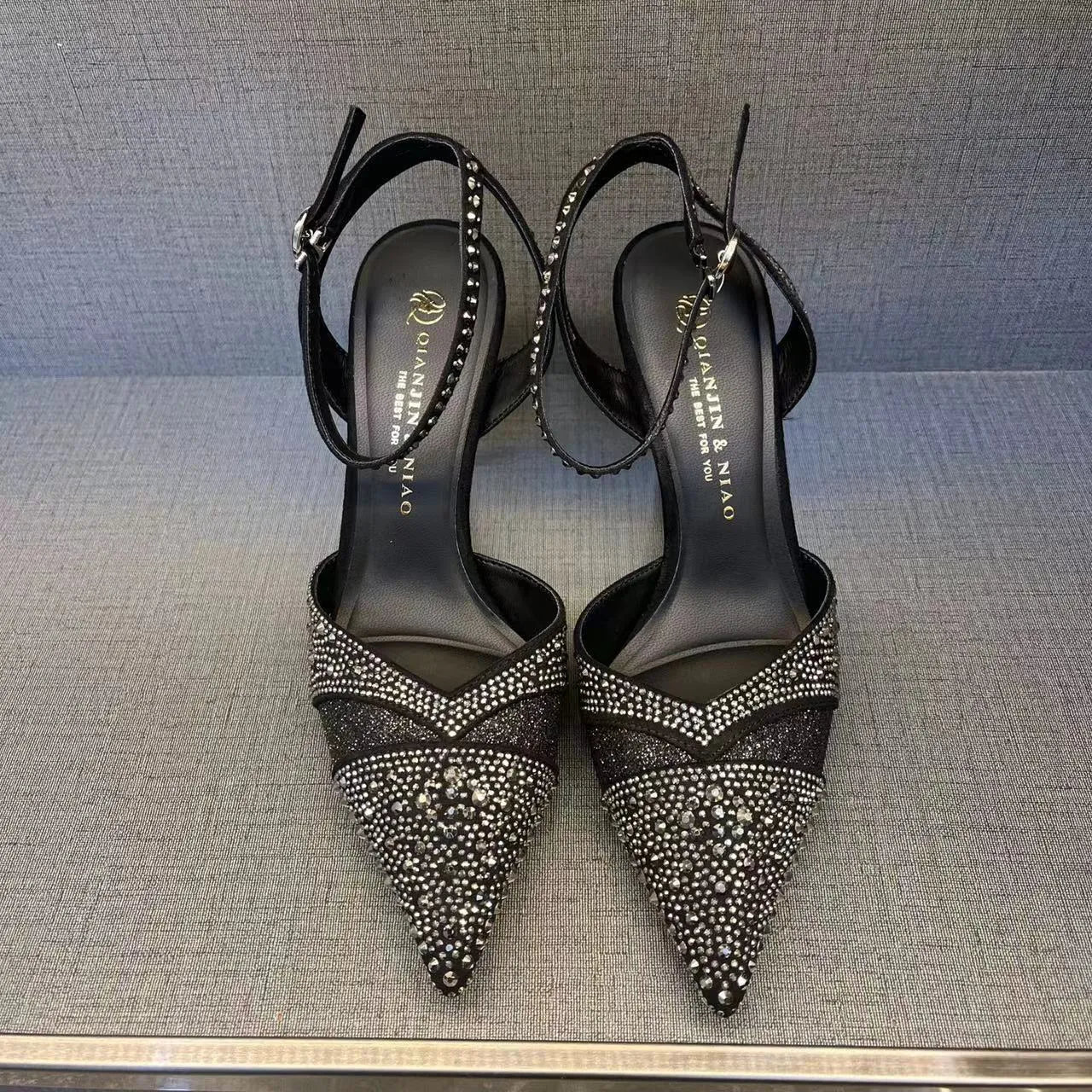 Women's hollow stiletto high heels with red sole and pointed toe design in black and silver options