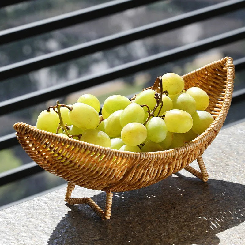 Plastic knitted basket fruit plate with dim sum snacks and melon seeds on a desktop