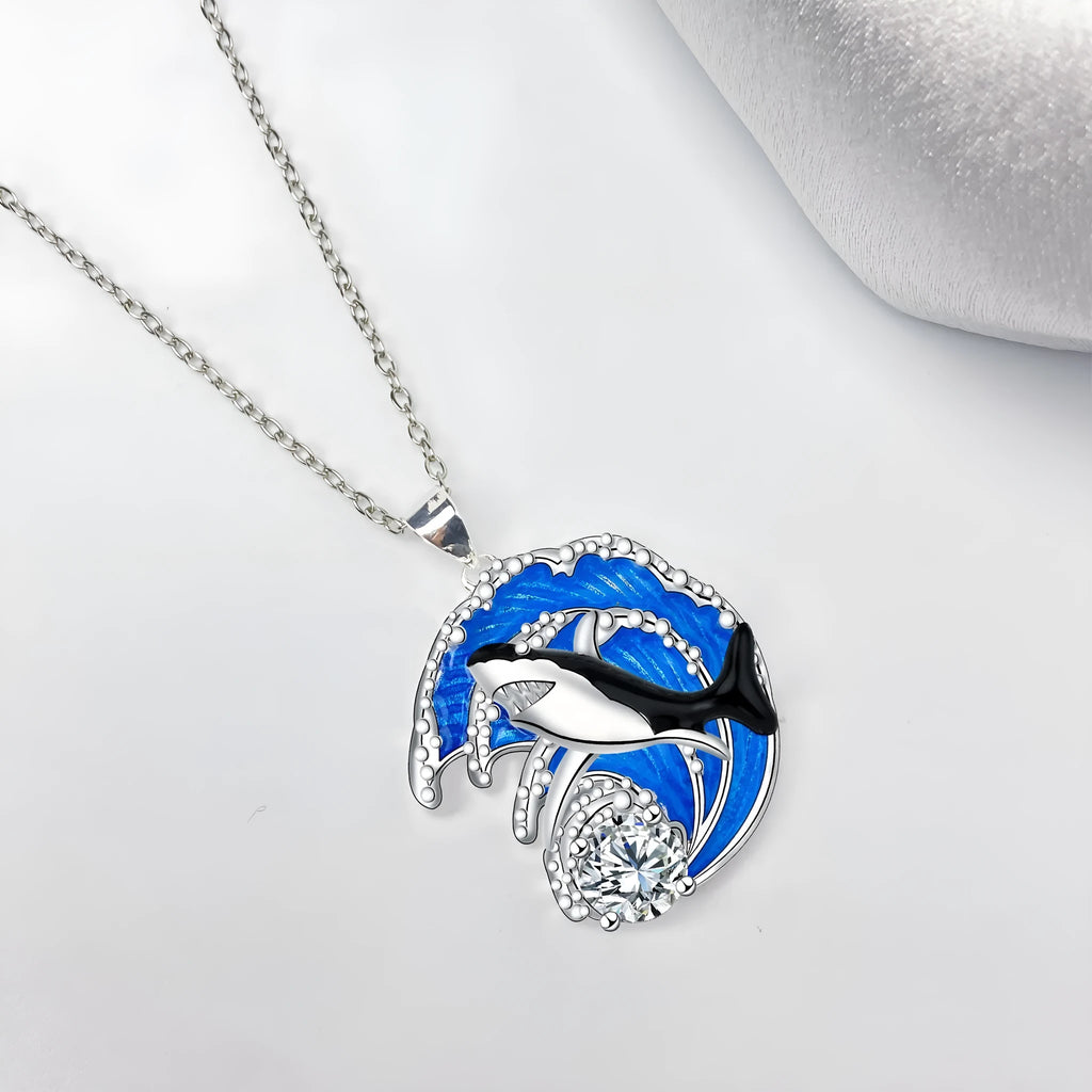 Silver shark pendant necklace on a cross chain, adjustable between 41cm and 50cm.