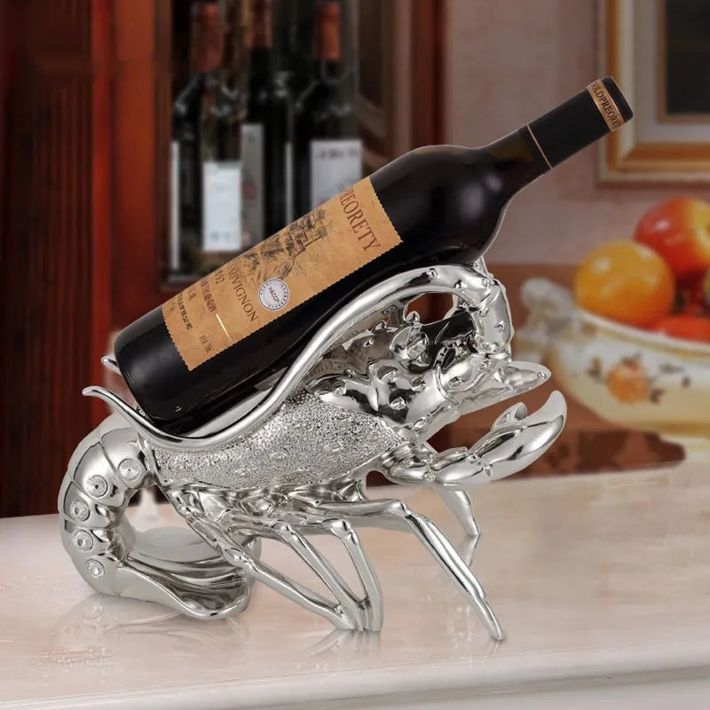 Metallic rose gold lobster-shaped resin ornament holding a wine bottle.