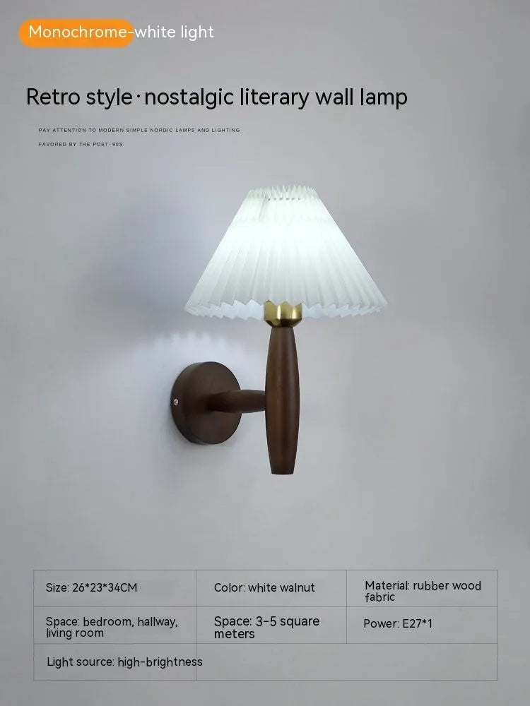 Retro wooden wall lamp with fabric shade in walnut finish mounted beside a bed.