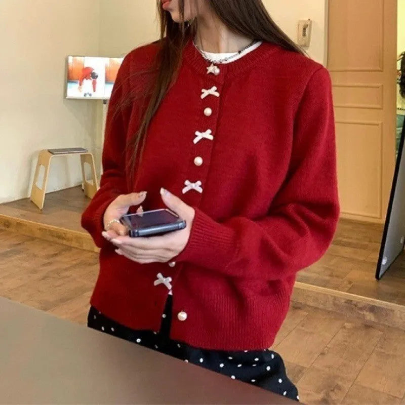 Women's cashmere blend cardigan sweater with pearl buttons and bow detail in solid colour