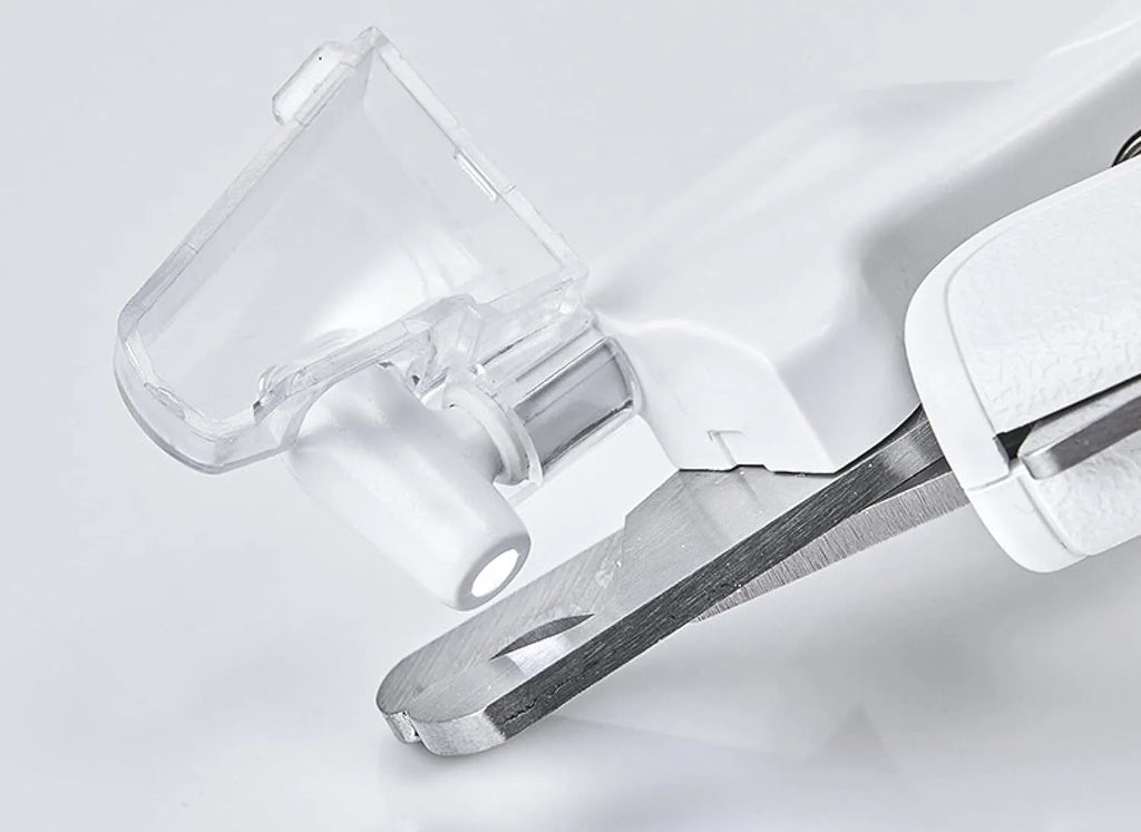 White pet nail clippers with LED light and transparent splash guard open, showing the triangular steel blade.