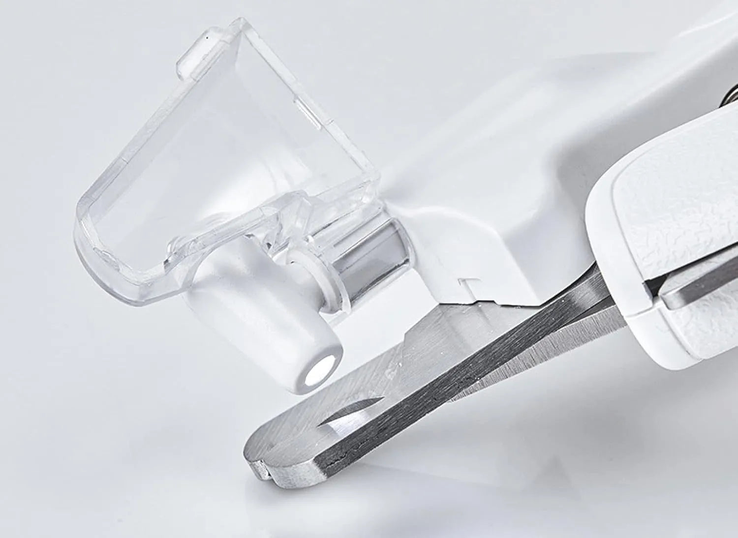 White pet nail clippers with LED light and transparent splash guard open, showing the triangular steel blade.