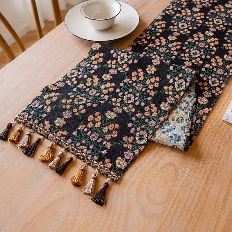 Nordic jacquard table runner with tassel trim in dark blue stripe pattern on wooden table