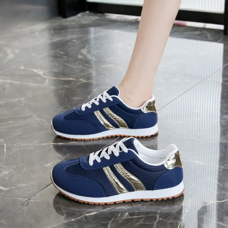 Blue women's casual tennis shoes with cross shoulder straps and white rubber sole.