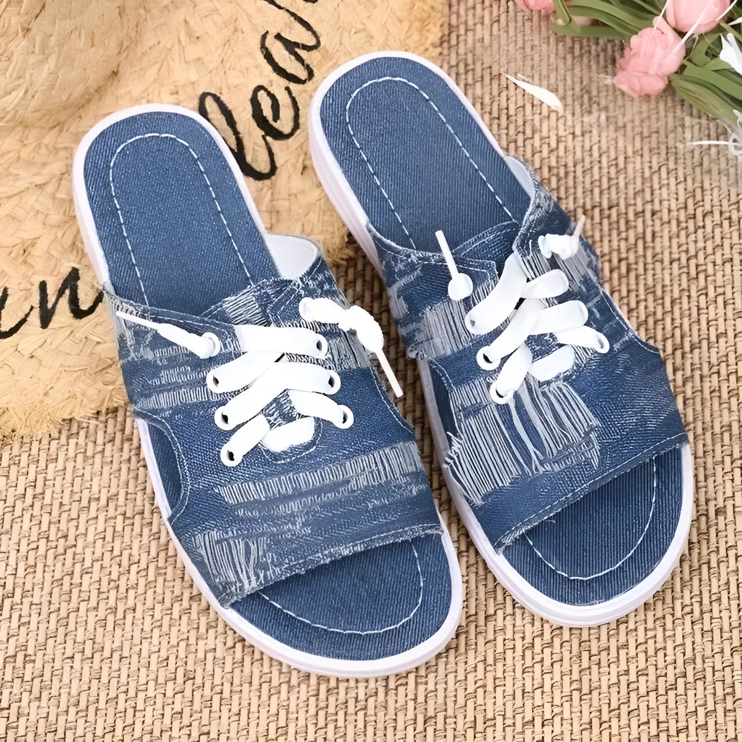 Blue women's flat canvas Roman style slippers with cloth upper and rubber sole.