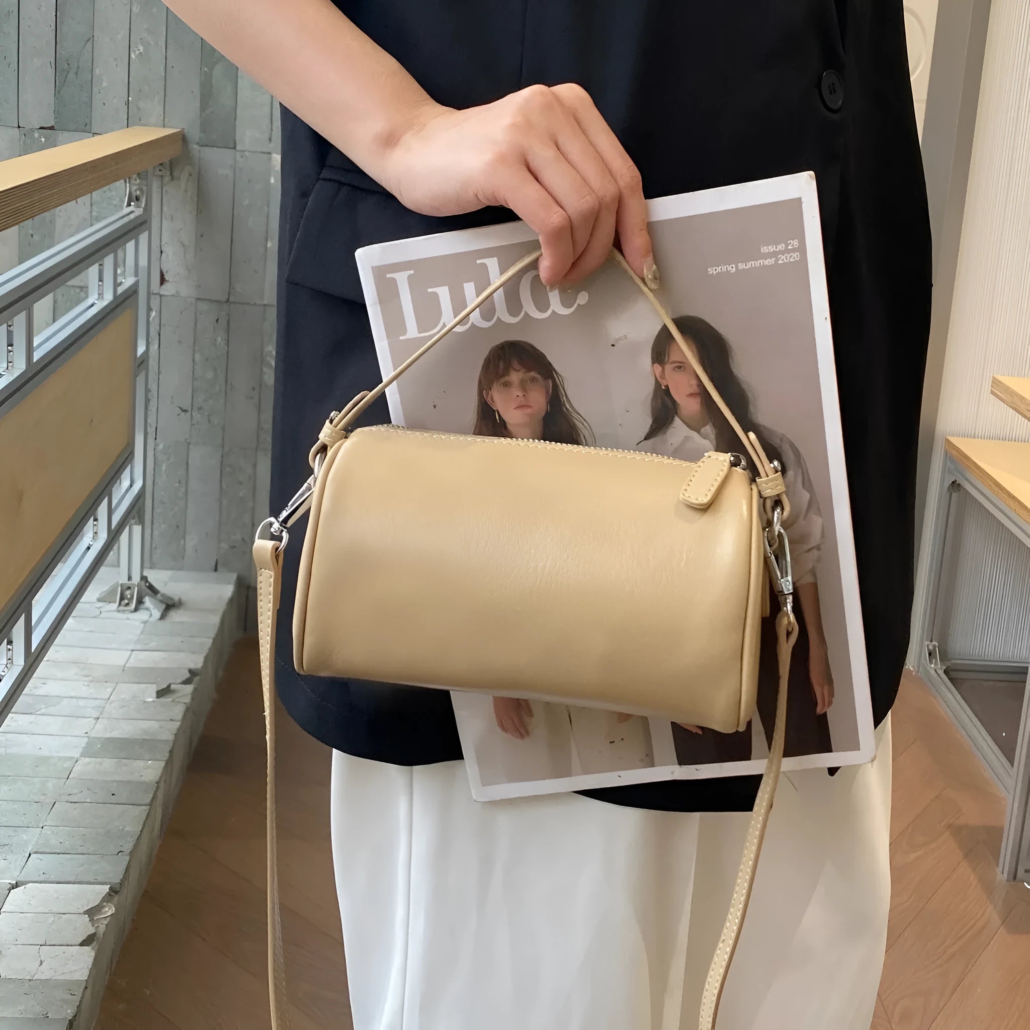 Genuine leather crossbody phone bag in cylindrical shape with single shoulder strap