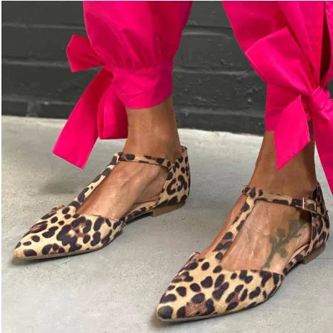 Leopard print women's pumps with pointed toe, chunky low heel, and ankle strap.