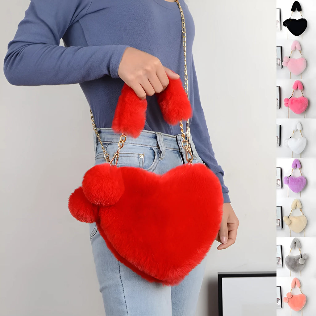 Soft plush heart-shaped women's handbag in a solid colour with a detachable shoulder strap.