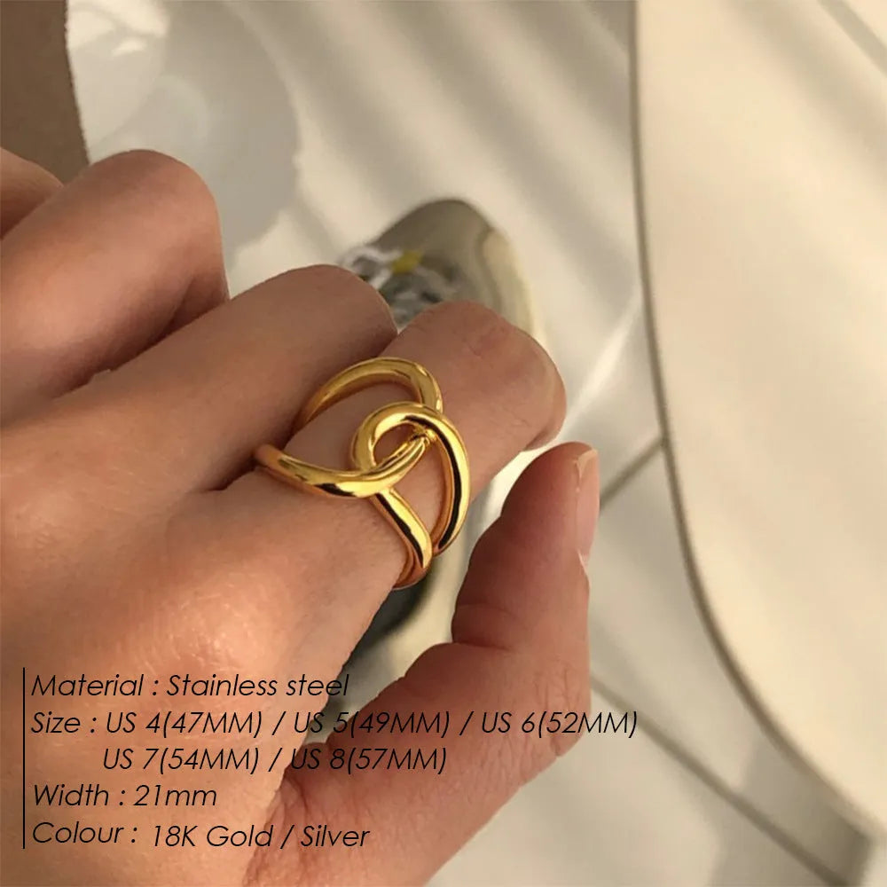 Women's stainless steel geometric ring with a knotted detail and adjustable opening in gold or steel colour.