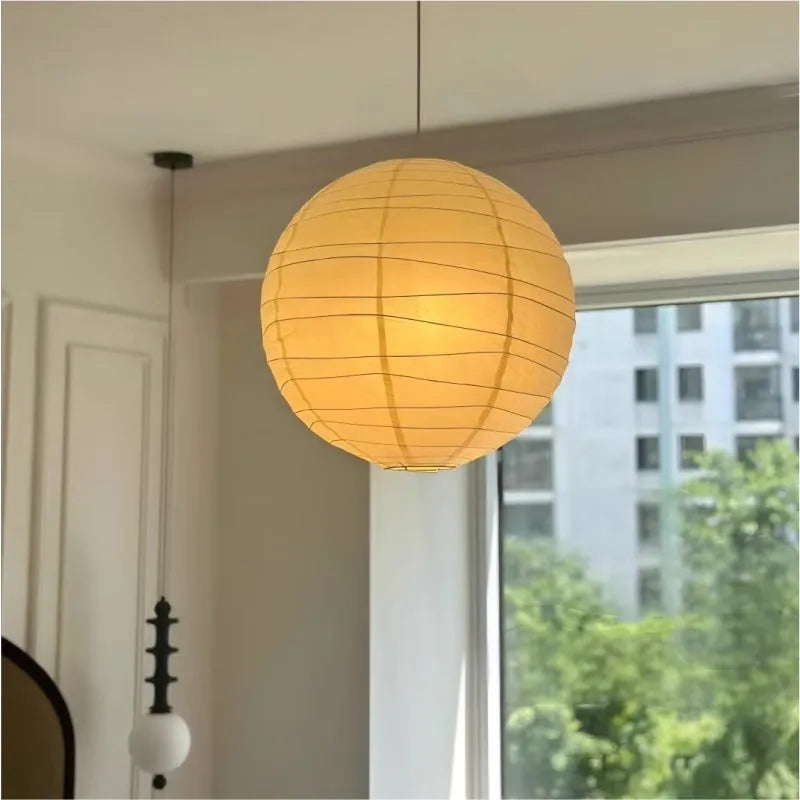 Japanese style rice paper pendant chandelier with soft glowing light.