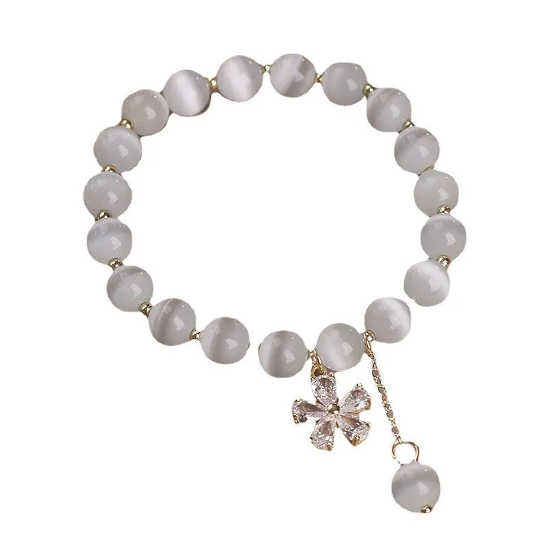 White cat's eye crystal bracelet with flower tassels and morganite safety buckle pendant.