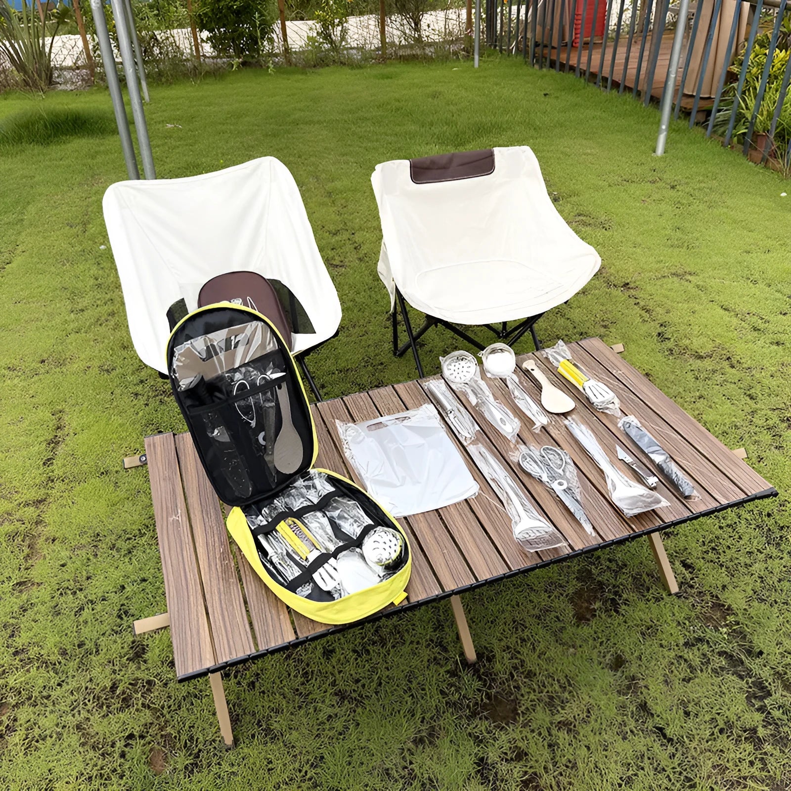 Portable khaki fabric bag containing a 12-piece stainless steel picnic cutlery set with knives, forks, spoons, and chopsticks.
