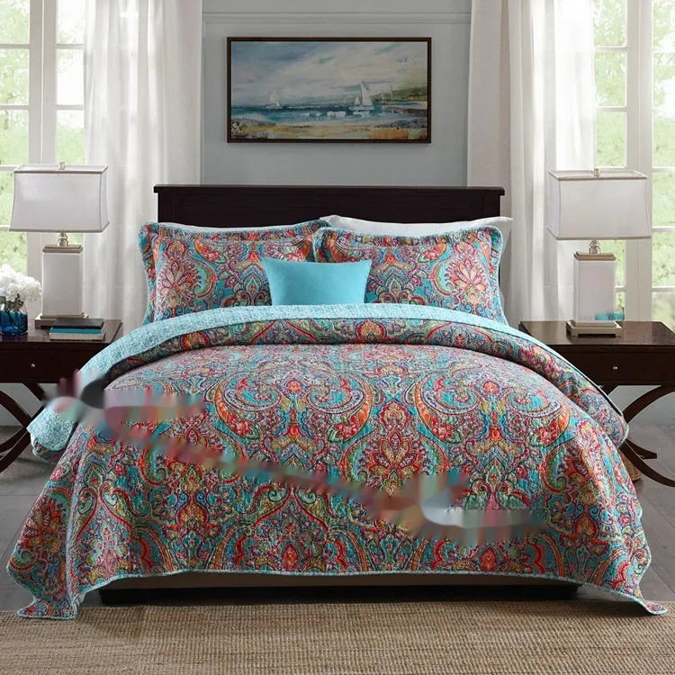 Quilted pure cotton bed cover set with two pillowcases in a colourful printed pattern.