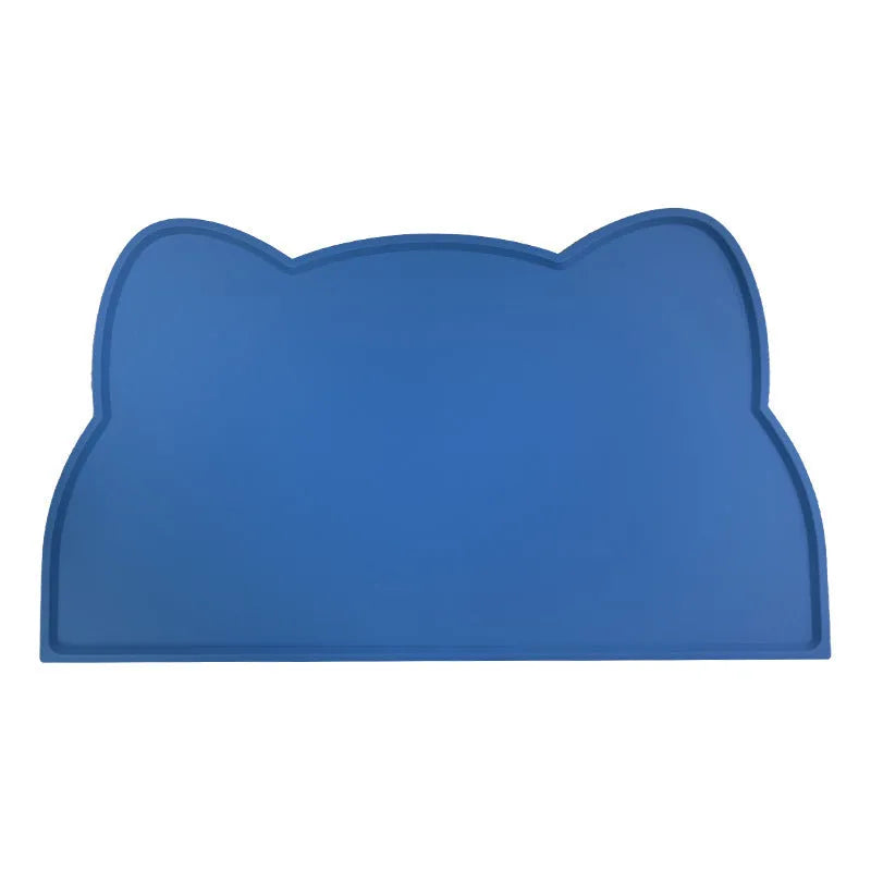 Blue silicone pet feeding mat under food and water bowls measuring 44 by 24 centimetres