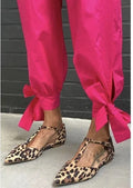 Leopard print women's pumps with pointed toe, chunky low heel, and ankle strap.