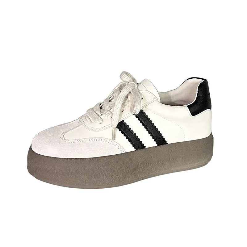 Women's beige vintage distressed leather sneakers with round toe and lace-up front on a rubber sole.